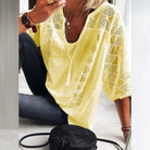 Detailed view of the U-ring collar accents on a breathable cotton blouse, adding a refined touch.