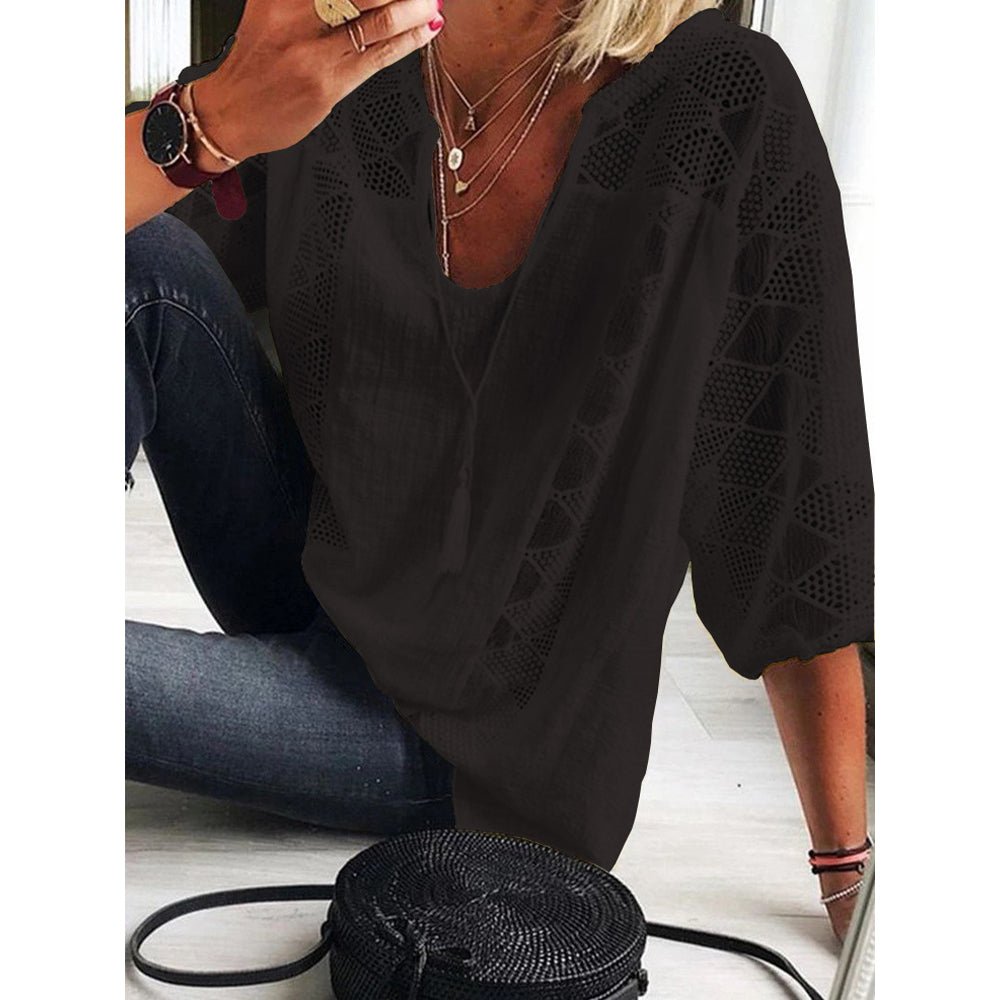 Lifestyle shot of a woman wearing a relaxed fit blouse, enjoying a sunny outdoor setting.