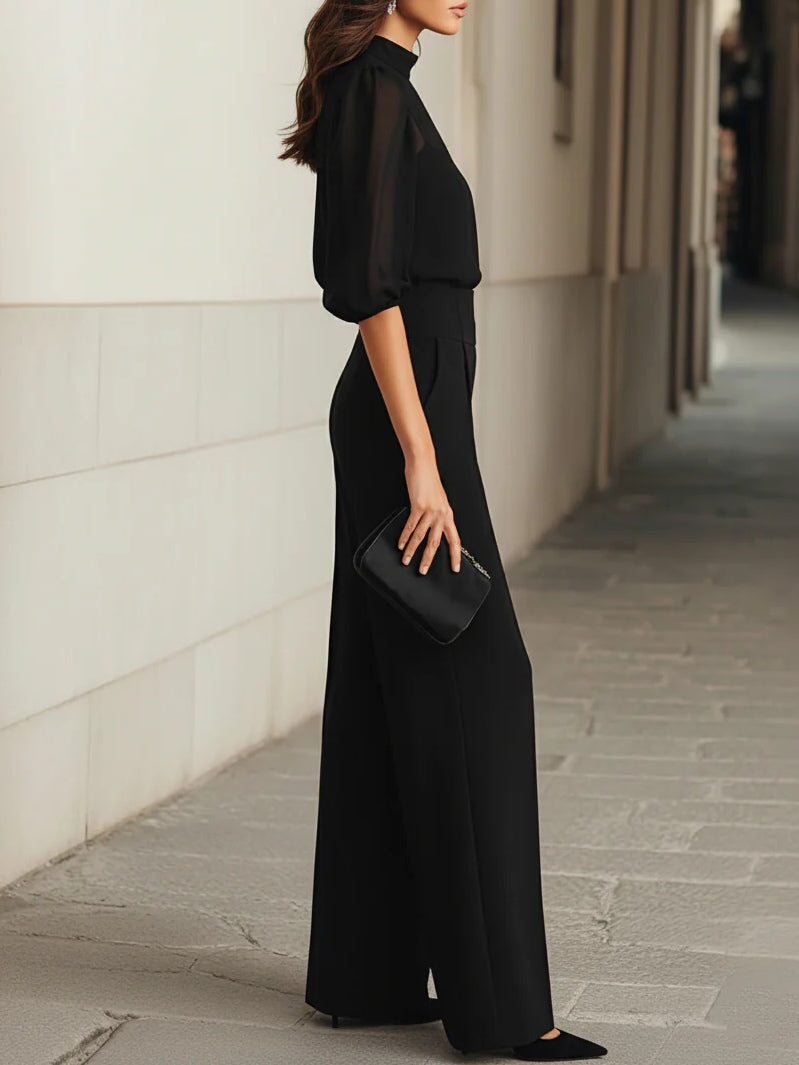Side profile of a model wearing the Indira elegant three-piece set, emphasizing the flowing silhouette of the wide-leg pants.