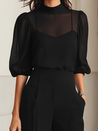 Back view of the Indira ensemble, revealing the elegant cut of the sheer top and the smooth lines of the three-piece set.