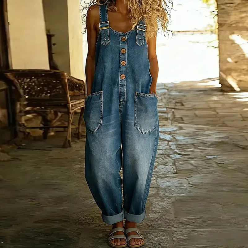 Side profile of a woman wearing Juniper relaxed fit denim overalls, highlighting the flattering drape and easy movement.