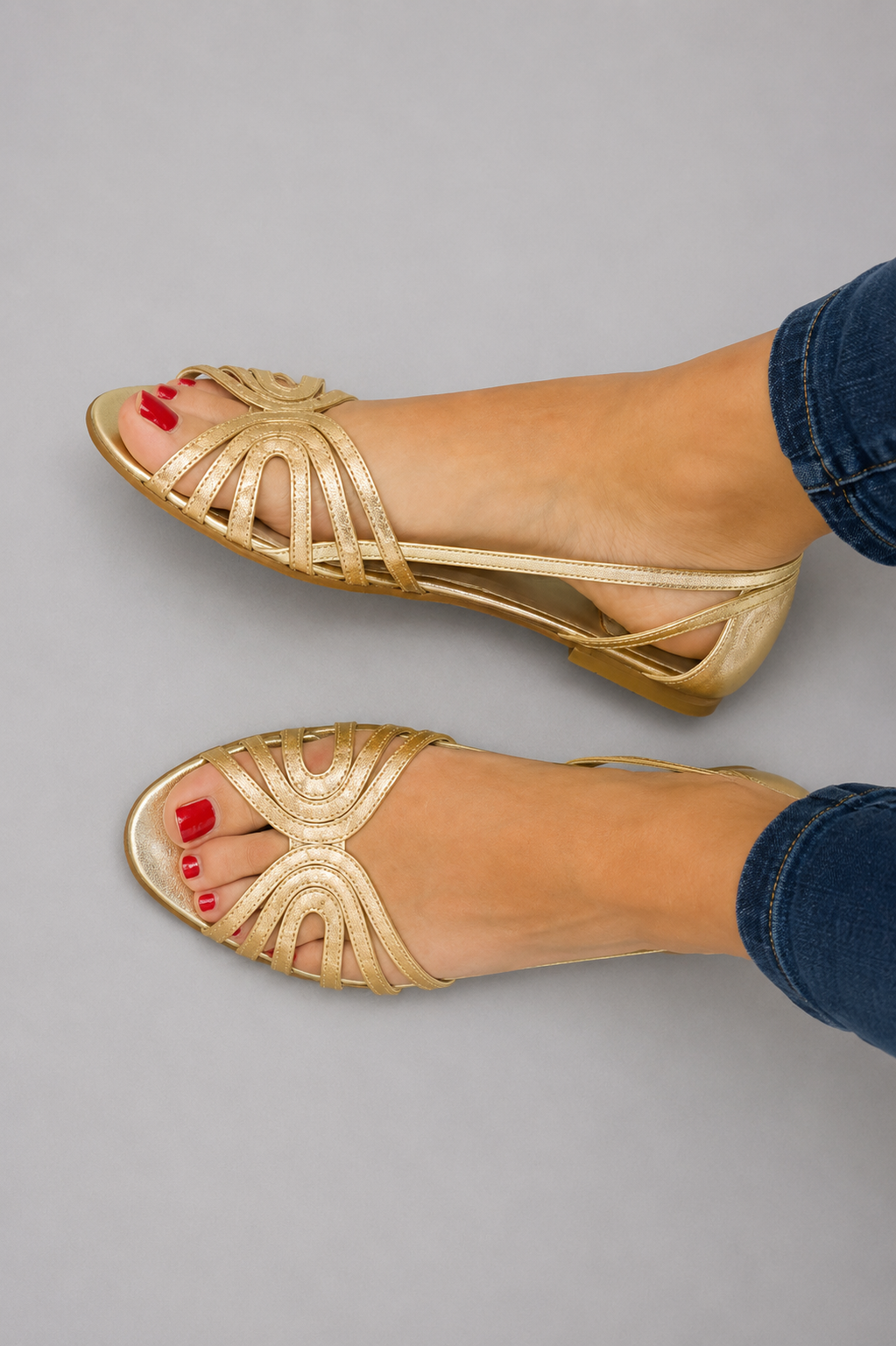 Pair of Kaelen vintage sandals in gold color, showcasing the elegant golden strap detail from a top-down view.