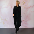 Rear view of the Katiya velvet maxi dress in black, showing the full length and overall elegant drape of the garment.