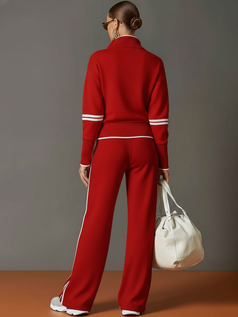 Woman casually leaning against a wall, showcasing the relaxed yet polished look of the wide-leg pants.