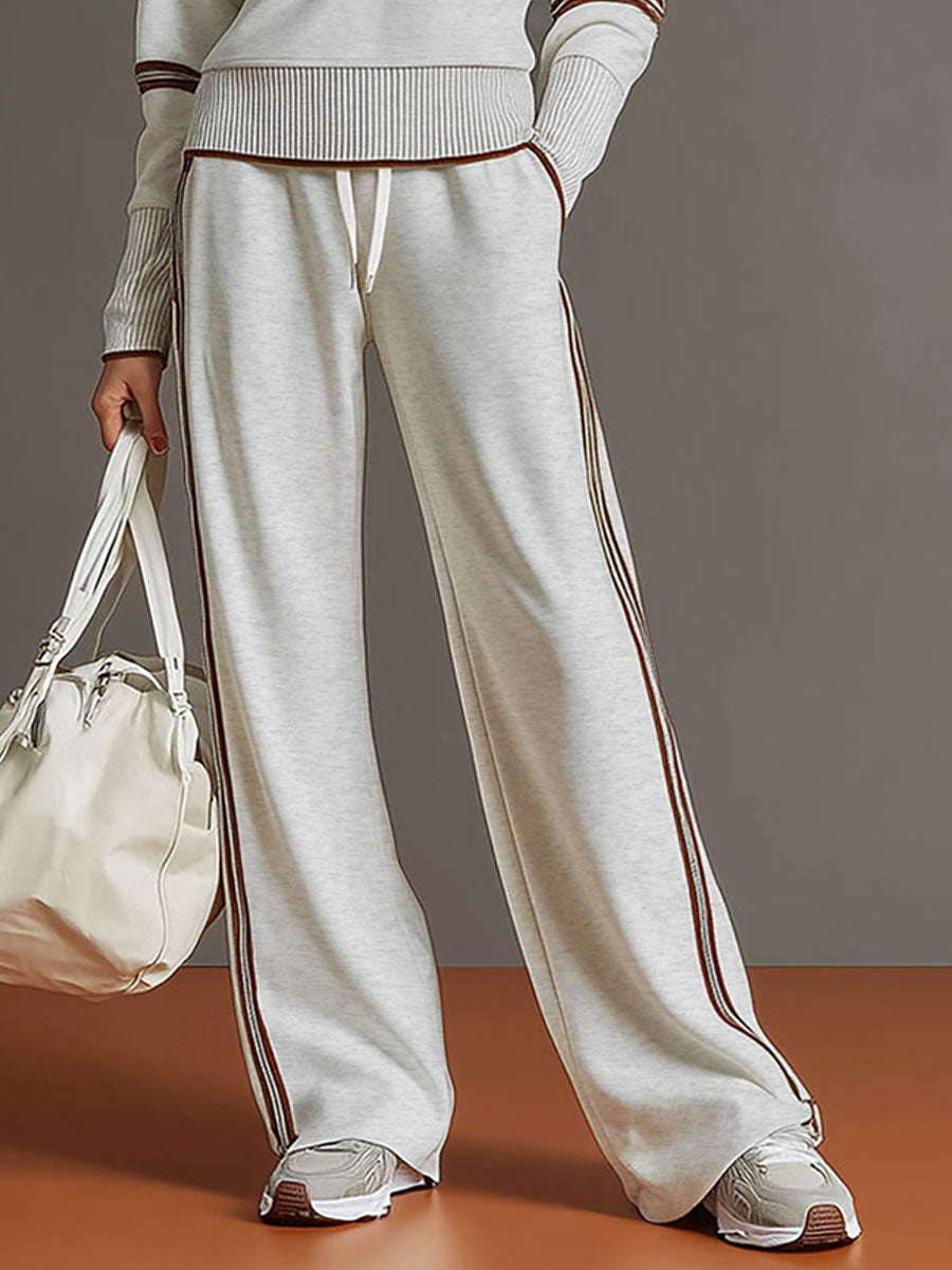 Another full-body shot of the woman from a different angle, emphasizing the flattering silhouette of the wide-leg pants.
