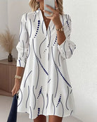 Front view of the Kora wavy stripe A-line dress in white, showcasing the lapel collar and button details.
