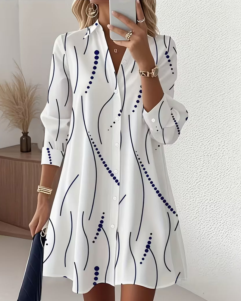 Front view of the Kora wavy stripe A-line dress in white, showcasing the lapel collar and button details.