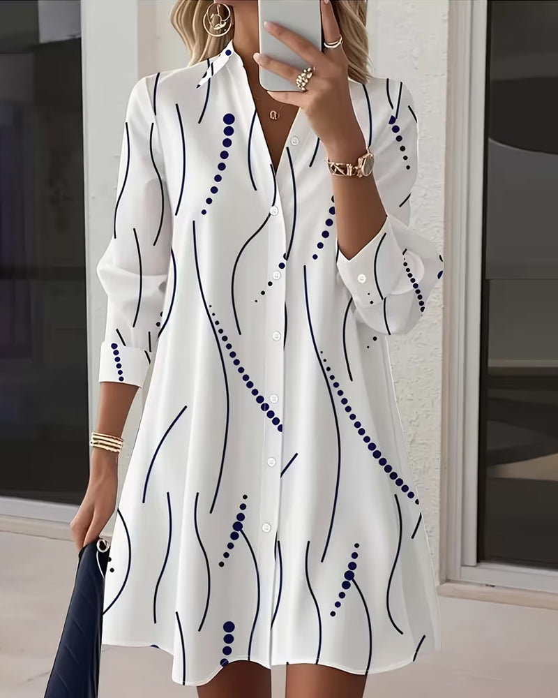 Side profile of a woman wearing the Kora dress, highlighting the flow of the wavy stripe fabric and long sleeves.
