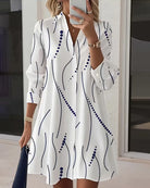Side profile of a woman wearing the Kora dress, highlighting the flow of the wavy stripe fabric and long sleeves.