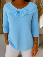 Front view of the Lana elegant knit tunic in a soft blue color, showcasing its loose fit and rounded neckline.