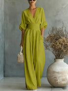 Rear view of a light blue jumpsuit, emphasizing the relaxed fit and elegant flow of the fabric.