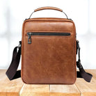 Side profile of the light brown Milo shoulder bag, illustrating its compact yet roomy design and structured form.