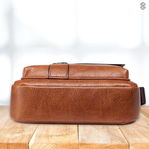 Interior view of the Milo modern shoulder bag, with a wallet and phone placed inside, demonstrating its organization.
