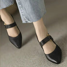 Side profile of brown leather slingback heels, highlighting the adjustable strap and gleaming gold-tone buckle.