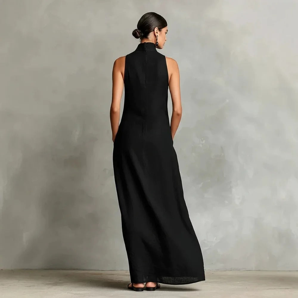 Close-up detail of the high stand-up neck and shoulder line on a navy blue sleeveless maxi dress.