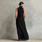 Close-up detail of the high stand-up neck and shoulder line on a navy blue sleeveless maxi dress.