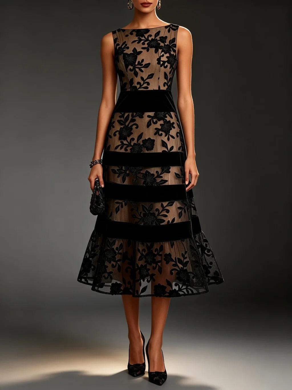 Close-up detail of the intricate floral embroidery on the bodice of the sophisticated black tulle midi dress.