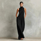 Rear view of a burgundy sleeveless maxi dress, displaying the long, graceful drape of the fabric.