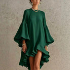 Side profile of a woman in a flowing white asymmetrical ruffle dress, highlighting the dramatic bell sleeves.