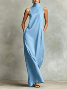A woman walking confidently in a navy blue sleeveless maxi dress, illustrating its comfortable movement and versatile style.