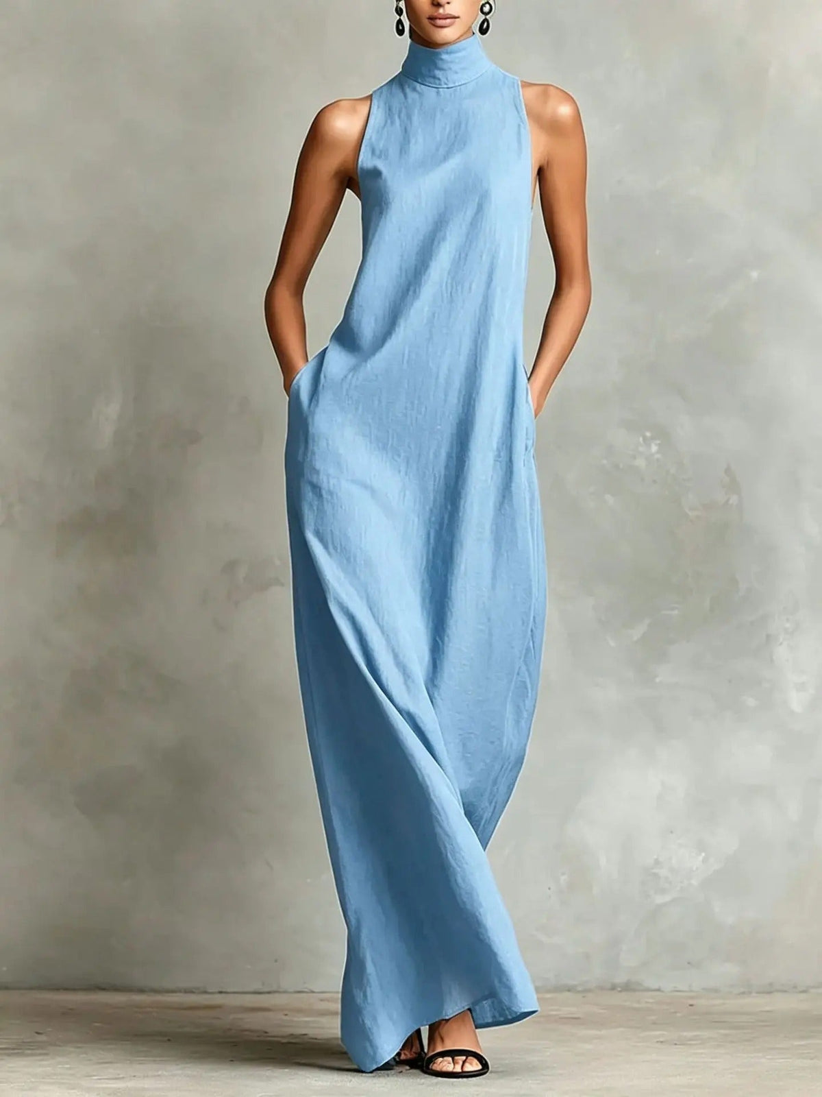 A woman walking confidently in a navy blue sleeveless maxi dress, illustrating its comfortable movement and versatile style.