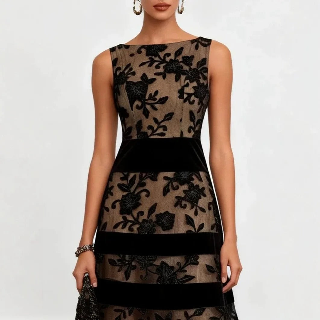 Elegant back view of the black embroidered tulle midi dress, revealing the refined silhouette and sheer fabric.