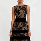 Elegant back view of the black embroidered tulle midi dress, revealing the refined silhouette and sheer fabric.
