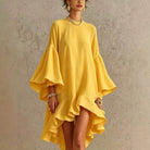Close-up detail of the ruffled hem on a dusty pink asymmetrical ruffle dress, showing its unique design.