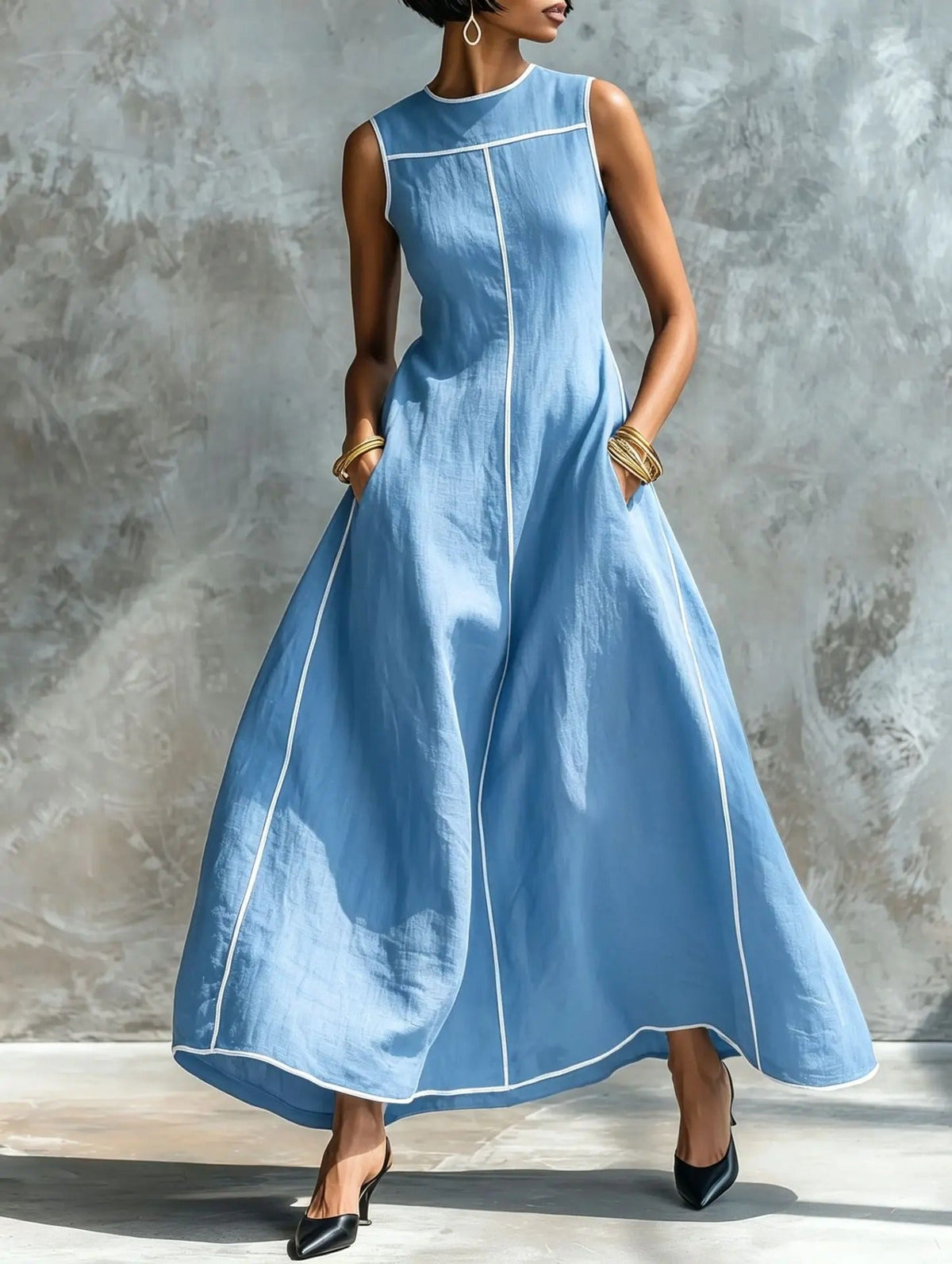 Stylish pink maxi dress with contrast trim, captured from a side profile to highlight its ankle-skimming length.