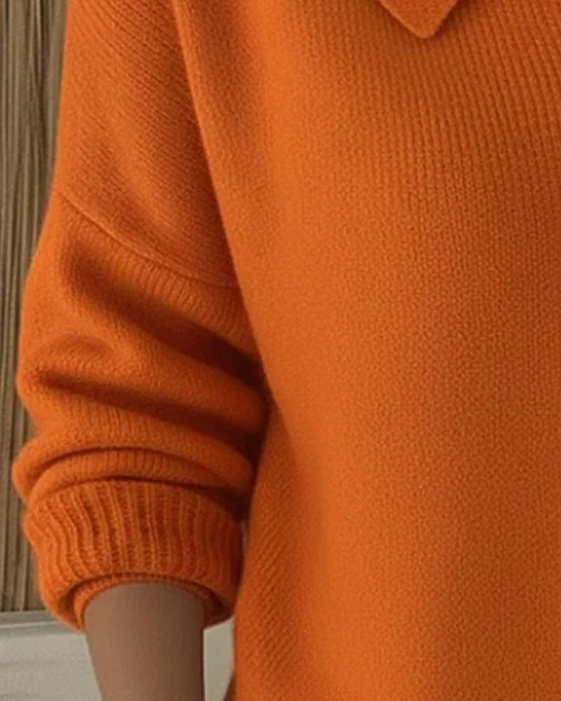 Marlow everyday cardigan in a bright orange, showcasing the smooth knit and simple sleeve finishes.