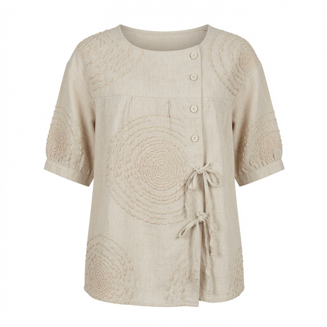 Close-up detail of the raised circular embroidery on the Mirabelle casual top's fabric surface.