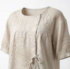 Rear view of the relaxed-fit Mirabelle embroidered top, demonstrating its comfortable silhouette.