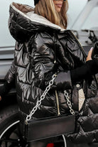Overhead shot of a beige hooded winter jacket laid flat, showcasing its full design and color.