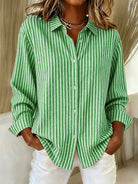Side profile of a woman wearing the blue Nina relaxed fit shirt, highlighting the long sleeves.