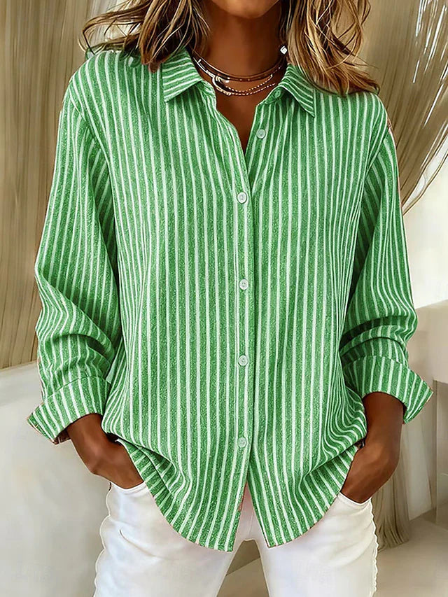 Side profile of a woman wearing the blue Nina relaxed fit shirt, highlighting the long sleeves.