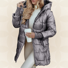 Close-up detail of the padded design on a pink hooded winter jacket, emphasizing the texture.