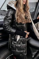 Lifestyle shot of a woman walking outdoors in a gray hooded winter jacket, illustrating its practical use.