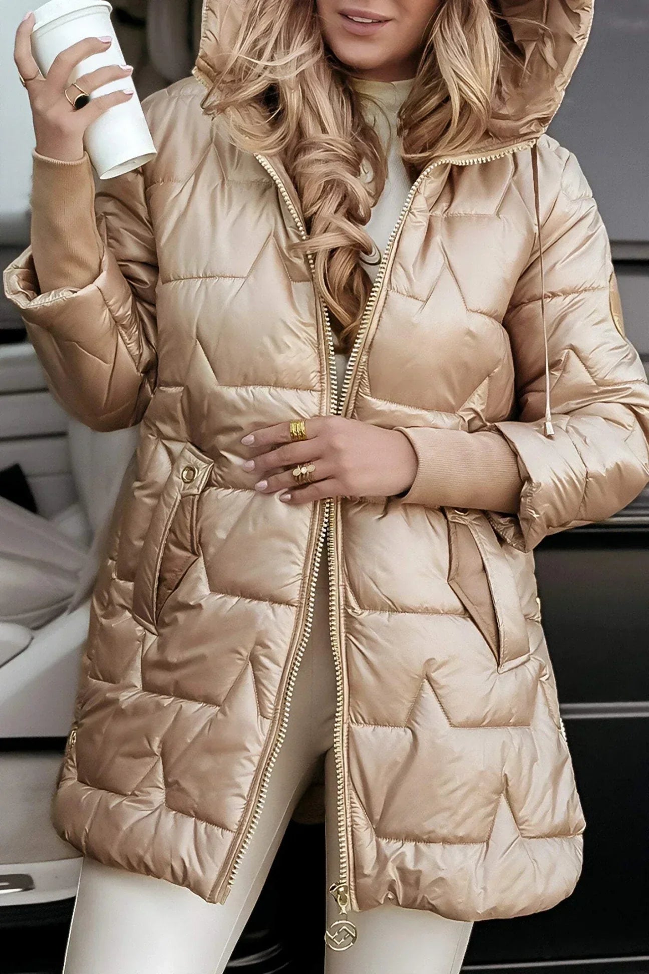 Detail shot of the hood on a pink hooded winter jacket, focusing on its protective design.