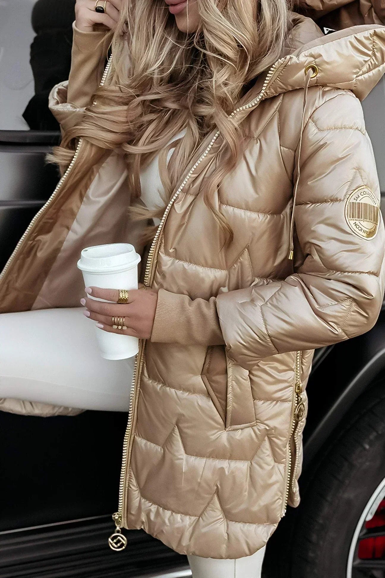 Close-up of the side pocket on a brown hooded winter jacket, demonstrating its convenience.