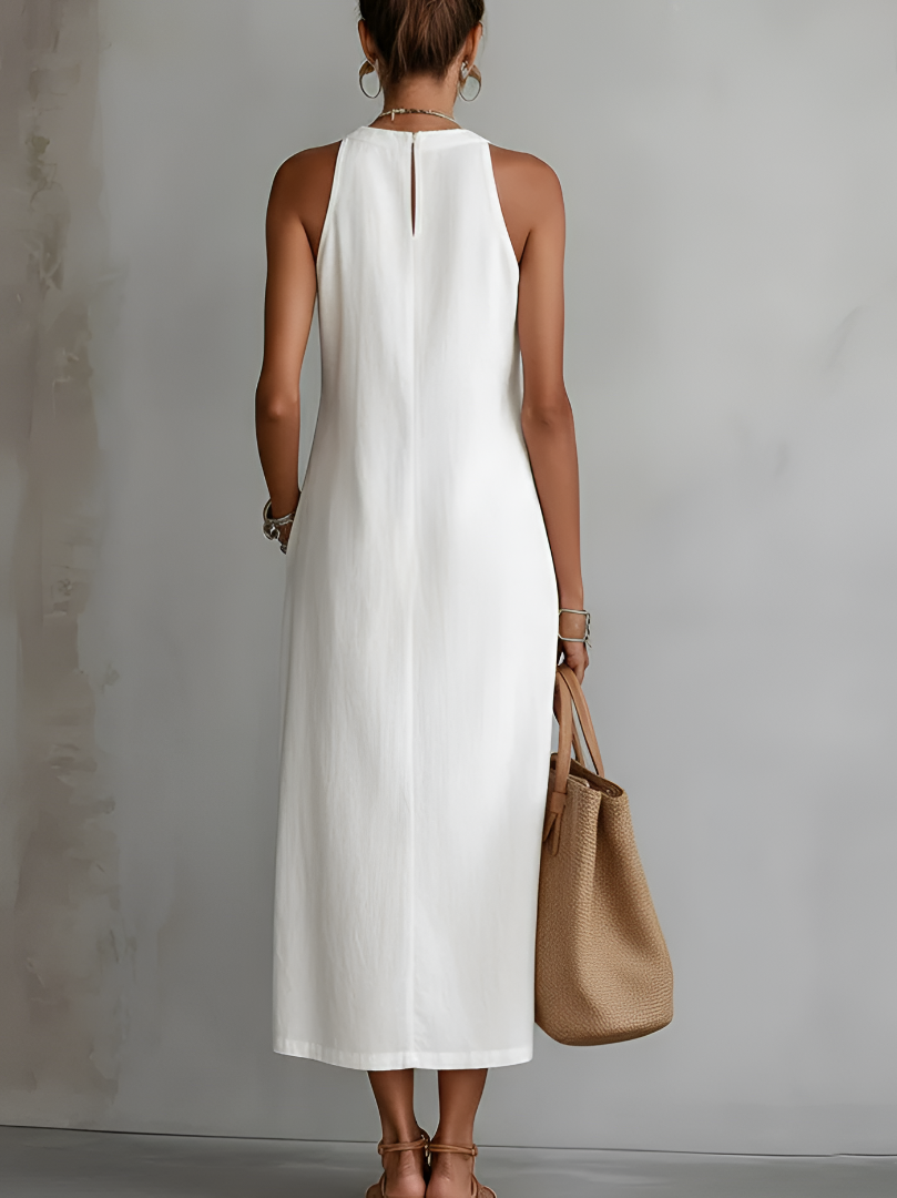 Side profile of a model wearing the green Adara midi dress, highlighting the flattering silhouette and side pockets.