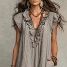 Close-up of the fabric texture on the white dress, emphasizing its breathable quality.