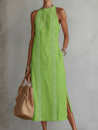 Lifestyle shot of a woman enjoying a warm day in the blue Adara dress, illustrating its comfortable elegance.