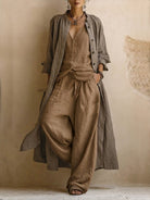 Close-up of a woman's legs in comfortable brown cotton linen blend trousers, showcasing the fabric texture and relaxed drape.