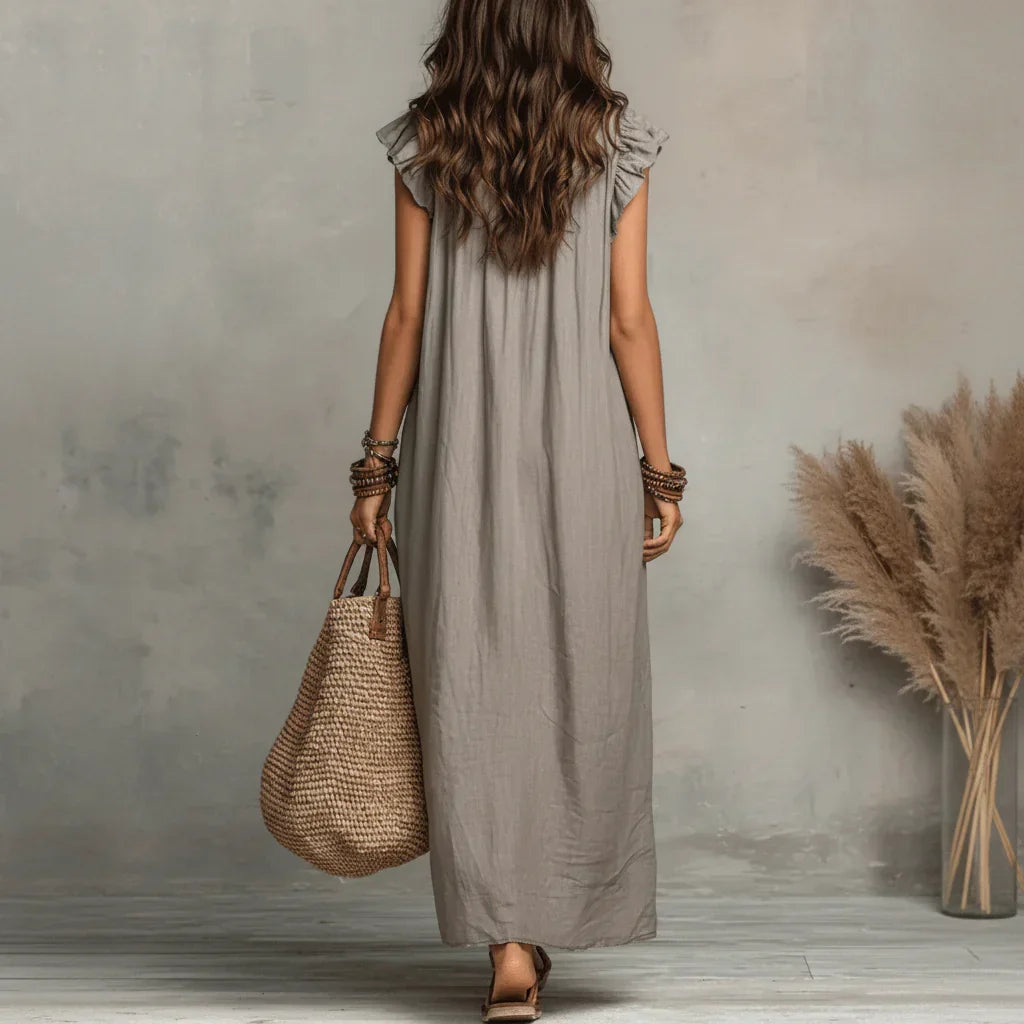 Flat lay of the black bohemian dress, displaying its full design and natural fabric texture.