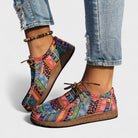 Top-down view of a pair of Peridot ultra-light orthopedic sneakers in a vibrant red, emphasizing the slip-on design.