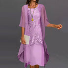 Detailed shot of the layered skirt and 3/4 sleeves on the Persephone elegant two-piece dress in lilac.