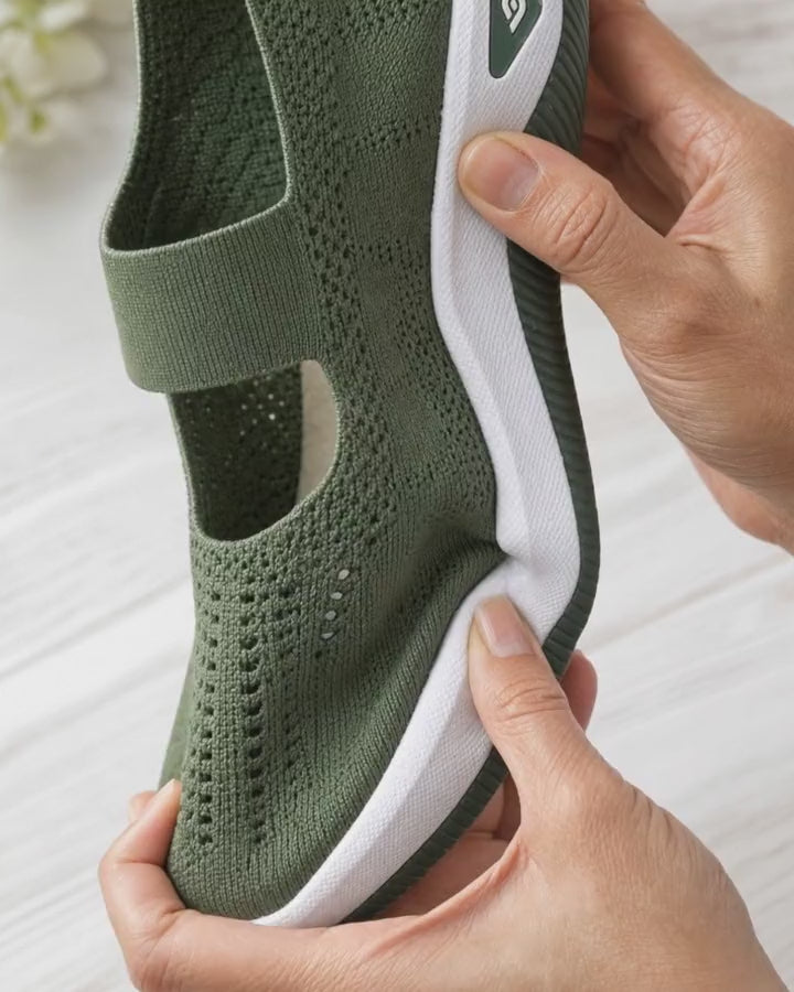 Fingers pressing the cushioned sole of the Carry slip-on to show the cushioning