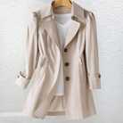 Close-up detail of the premium fabric texture and stitching on the Renata lightweight trench coat, showing quality.