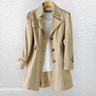 Side profile of the Renata elegant trench coat in pink, highlighting the adjustable tie belt and long sleeves.
