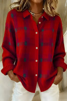 Side profile of a woman wearing the orange Sable relaxed fit cardigan, showcasing its loose drape.
